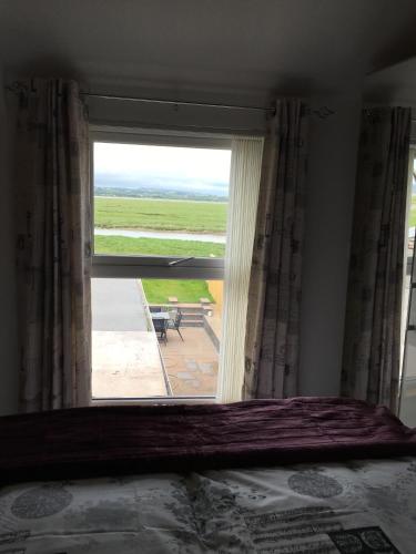 a window in a room with a view of a patio at Waters Edge in Penclawdd