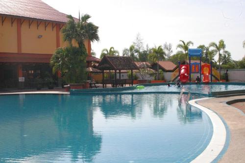 a pool at a resort with a water slide at Tanjung Demong Beach Resort in Kuala Besut