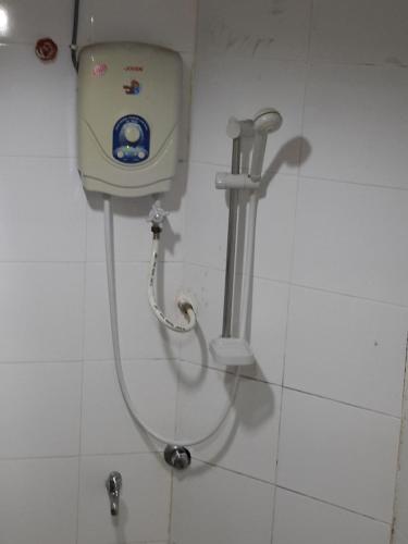a shower in a bathroom stall with a pump at Tanjung Demong Beach Resort in Kuala Besut