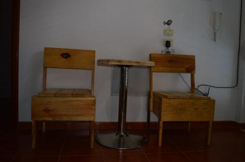 a room with two tables and a table and a stool at Arka Hostel in Shkodër