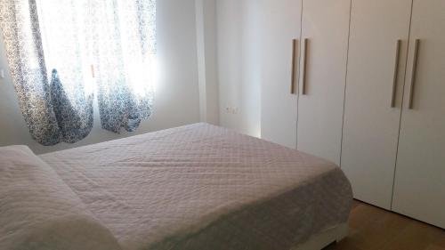 a bedroom with a bed and cabinets and a window at Casa Vacanze Spadafora 2 in Spadafora