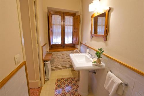 a bathroom with a sink and a window at Cal Barceló in Vandellós