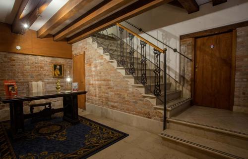 a staircase in a room with a brick wall at Cà Sant'Angelo in Venice