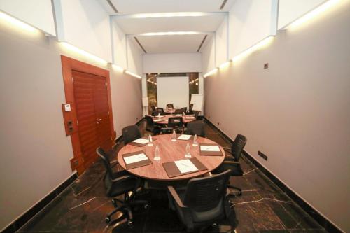 a conference room with a table and chairs in it at Urban Central Suites - Beirut in Beirut