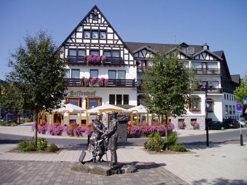a statue of two people in front of a building at Hotel Hessenhof in Winterberg
