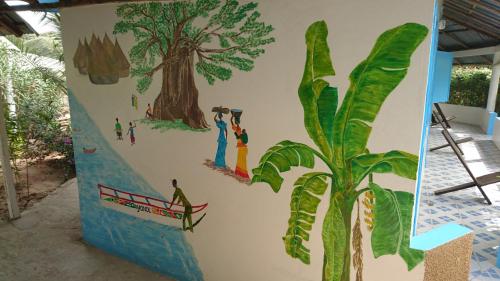 a wall with a tree and people painted on it at Guesthouse Yonol in Abene