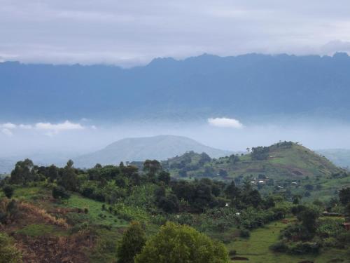a view of a mountain in the distance at Isunga Lodge in Kibale Forest National Park