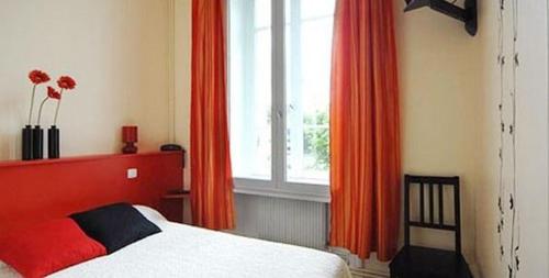 Una cama o camas en una habitación de L'Hôtel L'Astrée