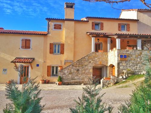 a large house with a stone wall at Apartment HUM-the smallest town in the world in Hum