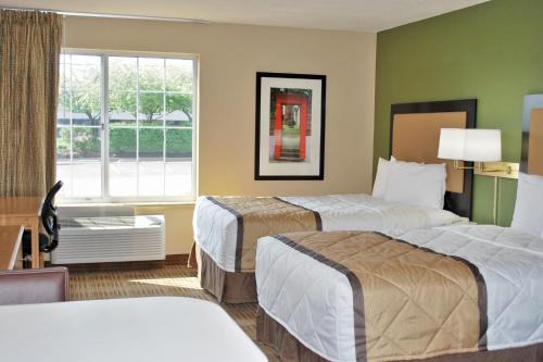 a hotel room with two beds and a window at Extended Stay America Suites - Minneapolis - Eden Prairie - Technology Drive in Eden Prairie