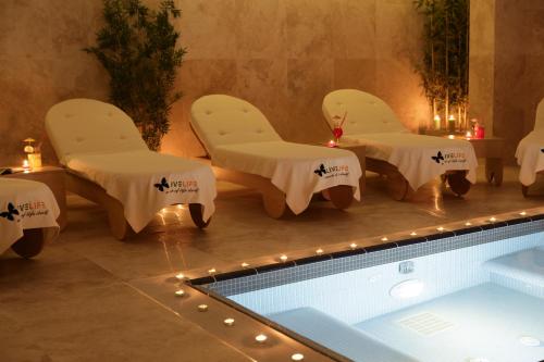 a swimming pool with two chairs and a table and a swimming pool at RYS Hotel in Edirne