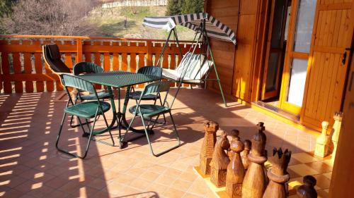 a patio with a table and chairs and an umbrella at Chalet Il Fungo in Averara