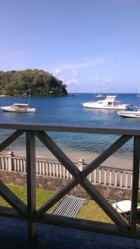 a view of the water with boats on the beach at Paradise Beach Hotel in Kingstown