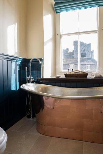 a large bath tub in a bathroom with a window at The Priory in Middleham
