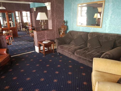 a living room filled with furniture and a couch at The Embassy Hotel in Great Yarmouth