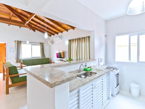 a kitchen with a sink and a counter top at Residencial JL Maresias in Maresias