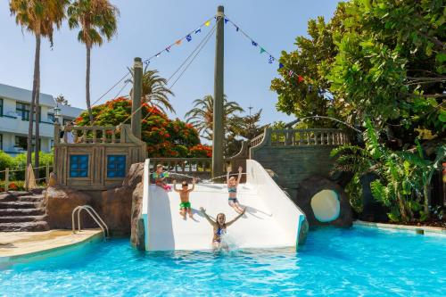 a group of children playing on a water slide at a resort at H10 Lanzarote Princess in Playa Blanca