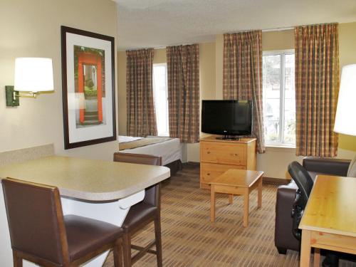 a hotel room with a living area with a television at MainStay Suites Las Vegas Convention Center in Las Vegas