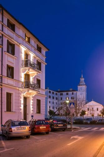 a city street with cars parked in front of a building at Apartments Villa Castello in Crikvenica