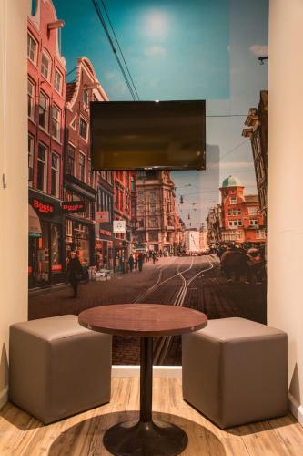 a table in a room with a picture of a street at Royal Plaza Hotel Amsterdam in Amsterdam