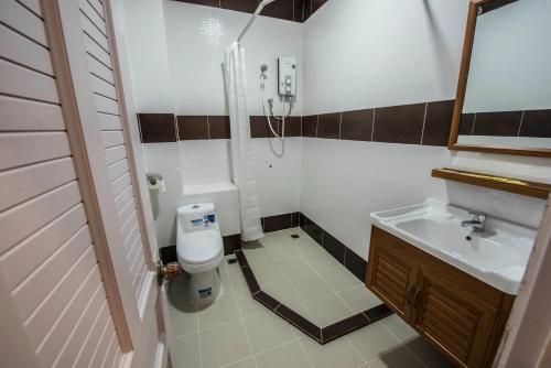 a bathroom with a toilet and a sink at Phnom Penh Le Vincent Hotel in Phnom Penh