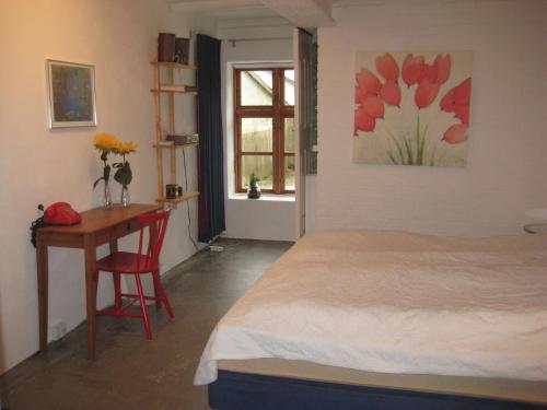 una camera con letto, scrivania e finestra di Billund Resort – Ravning a Bredsten