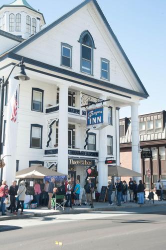 a group of people standing outside of a white building at Thayers Inn in Littleton