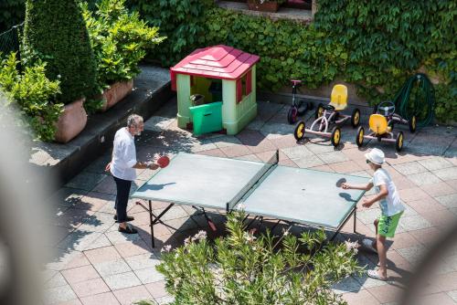 two people playing ping pong on a ping pong table at International au Lac Historic Lakeside Hotel in Lugano