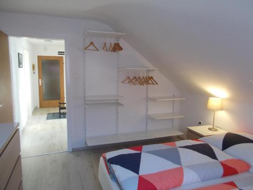 a bedroom with a bed and a staircase with shelves at Apartment Seven Ducks in Aalen