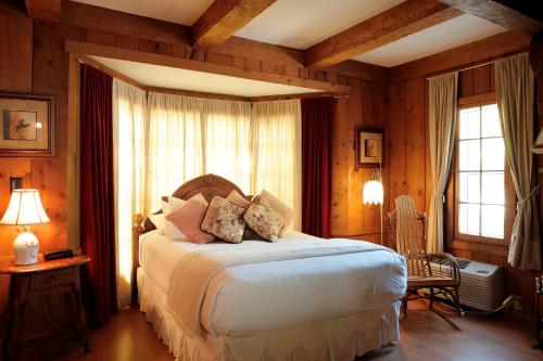 a bedroom with a large bed in a room with wooden walls at Peninsula Park-View Resort in Fish Creek