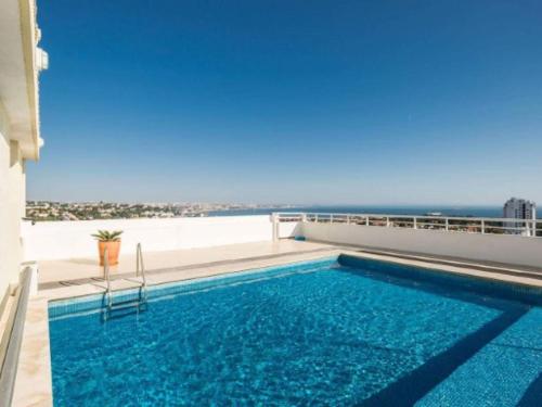 a swimming pool with a view of the ocean at Torre Mar Apartment in Cascais