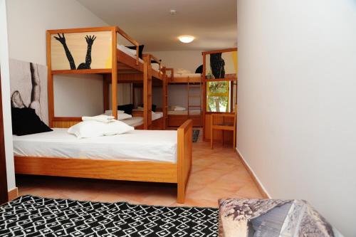 a room with two bunk beds and a desk at Caparica Sun Centre in Costa da Caparica