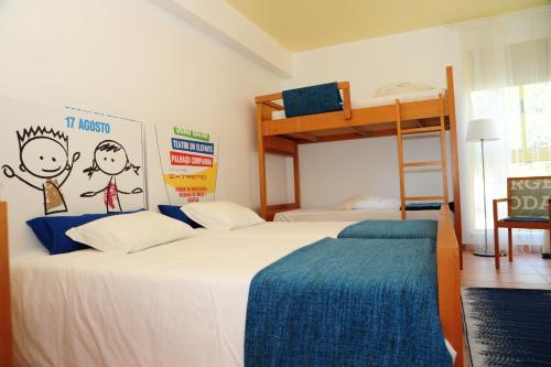 a bedroom with two beds and a bunk bed at Caparica Sun Centre in Costa da Caparica