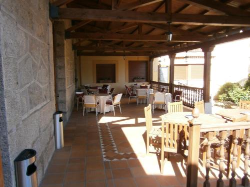 a patio with tables and chairs on a building at Hotel El Castrejon in Cebreros