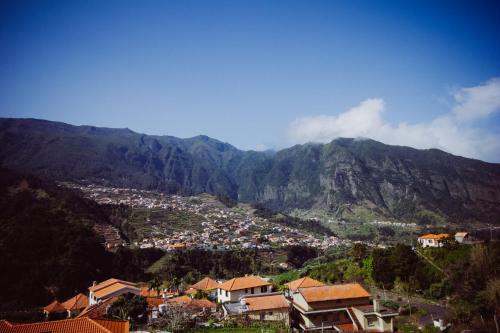 a view of a town in front of a mountain at Solar da Bica in São Vicente