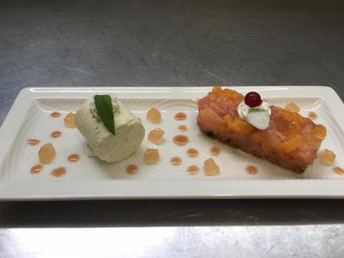 a white plate with a piece of food on it at Logis Le Midland in Vichy