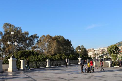 a group of people walking and riding bikes on a bridge at La Casa di Aurora in Reggio Calabria