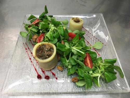 a plate of food with a salad and vegetables at Logis Le Midland in Vichy