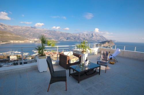 a balcony with a view of the ocean and mountains at Apartments Spas in Budva
