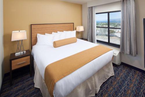 a hotel room with a large bed and a window at Red Lion Ridgewater Inn & Suites Polson in Polson