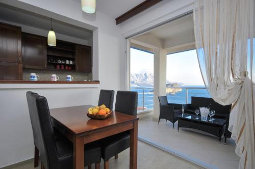 a kitchen and dining room with a table and chairs at Apartments Spas in Budva