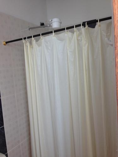 a shower curtain is hanging in a bathroom at Hotel Internacional Jardín in Jardin