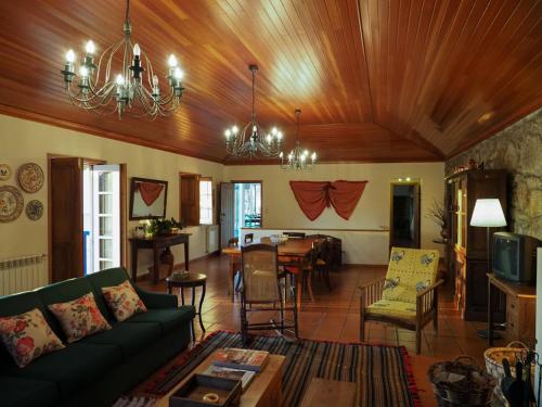 a living room with a couch and a dining room at Quinta da Pereirinha in Arcos de Valdevez