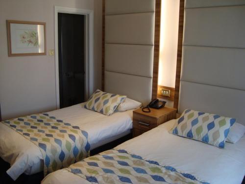 a hotel room with two beds and a telephone at Royal Eagle Hotel in London