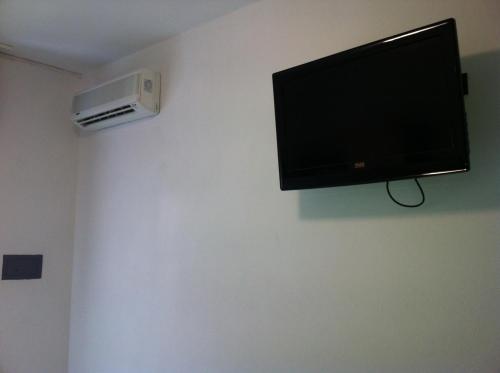 a flat screen tv hanging on a wall at Hotel Olanda in Lido di Jesolo