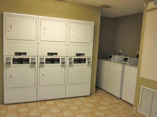a bunch of white cabinets in a kitchen at Extended Stay America Suites - Austin - Downtown - Town Lake in Austin