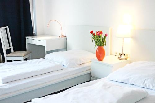 a bed room with two beds and a lamp at MAC City Hostel in Hamburg