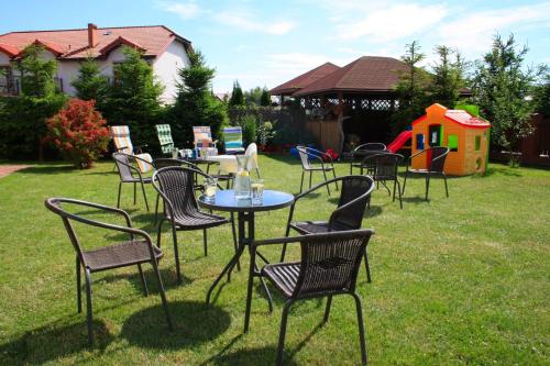 a group of chairs and tables in a yard at Apartamenty Fala in Rowy