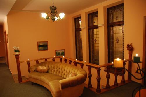 a living room with a couch and some candles at Kyjovský pivovar - hotel, restaurace, pivní lázně in Kyjov