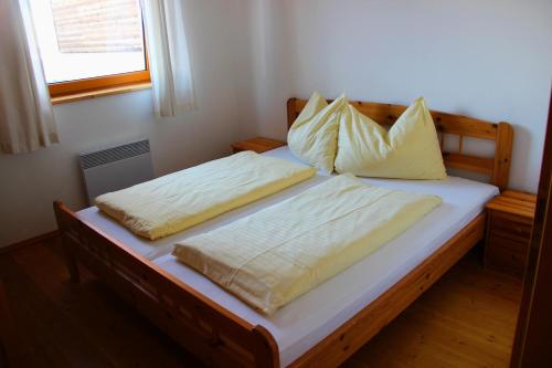 a bed with two pillows on top of it at Juniorsuite in Turracher Hohe